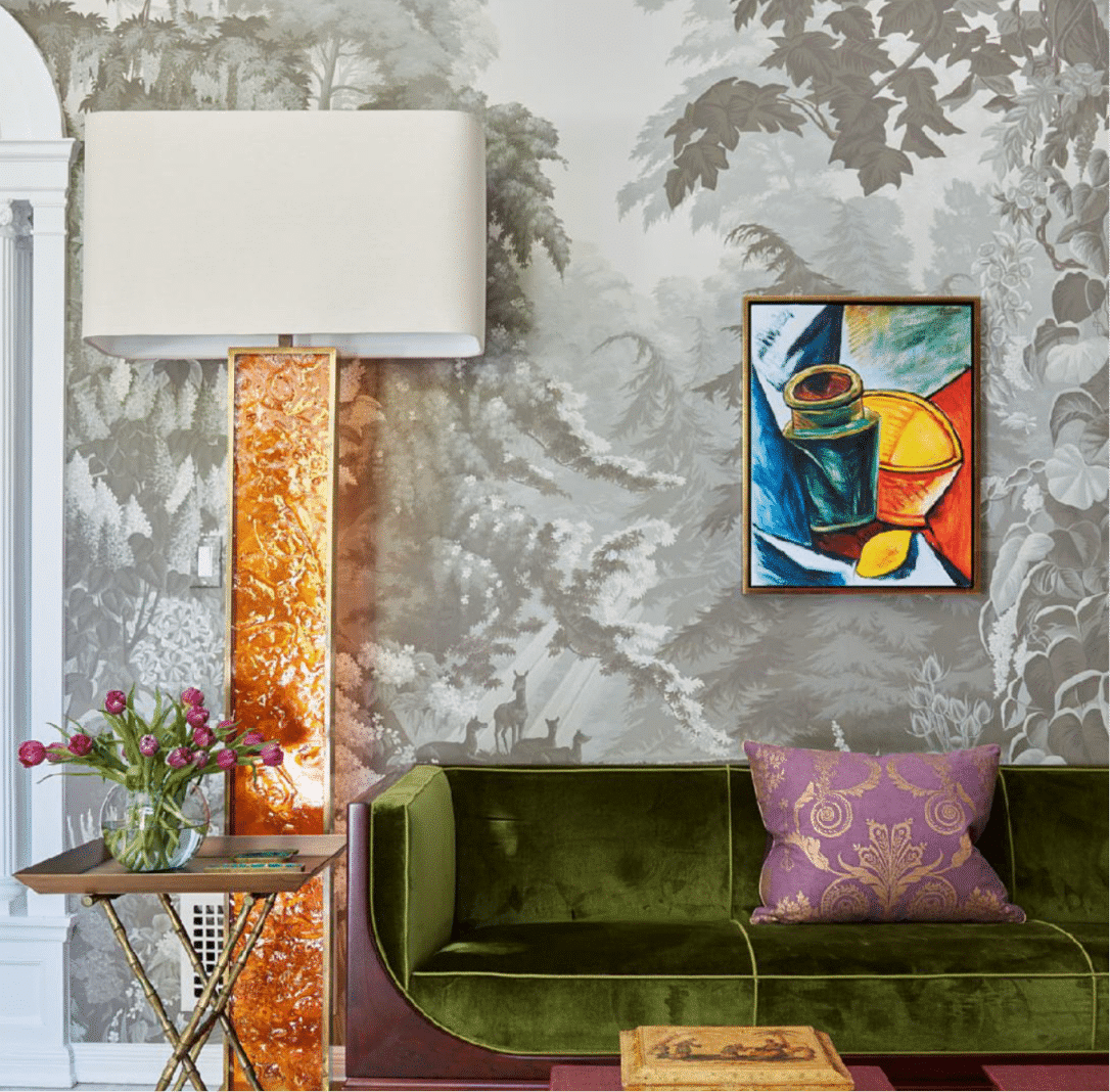 Colorful reading room with artistic wallpaper and flowers.